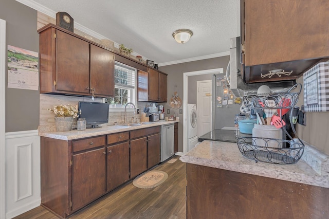 kitchen with crown molding, washer / clothes dryer, light countertops, appliances with stainless steel finishes, and a sink