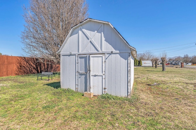 view of shed featuring fence