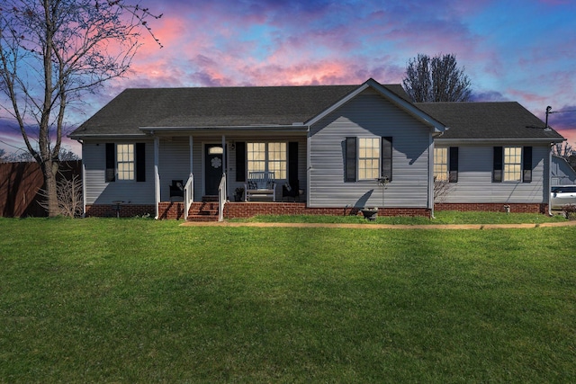 ranch-style home featuring covered porch, crawl space, and a lawn