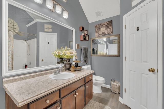 bathroom featuring visible vents, toilet, a shower with curtain, wood finished floors, and vanity