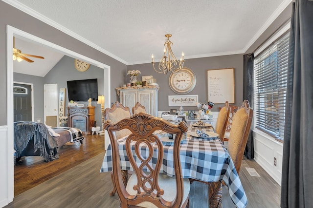 dining space with visible vents, crown molding, a textured ceiling, and wood finished floors