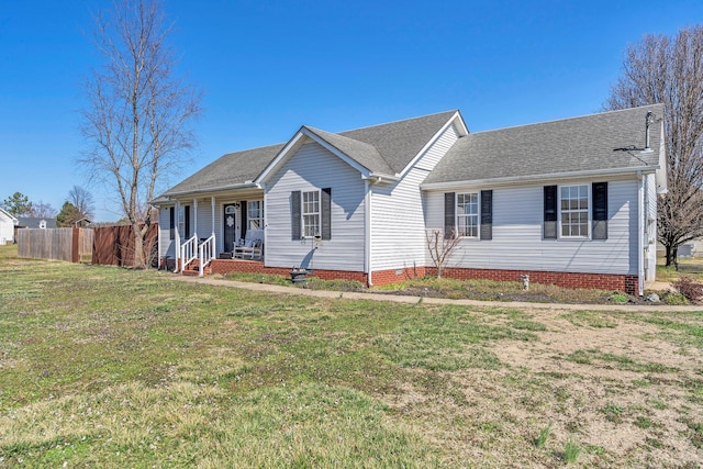 ranch-style home featuring covered porch, a shingled roof, fence, and a front yard