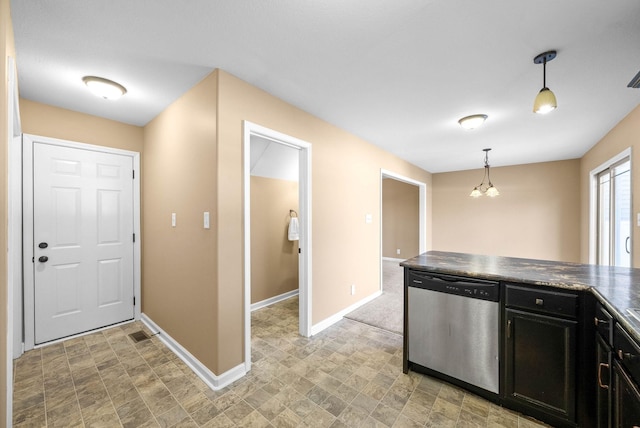 kitchen featuring baseboards, dishwasher, dark countertops, dark cabinets, and decorative light fixtures