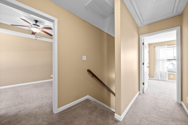 corridor with attic access, baseboards, visible vents, carpet flooring, and an upstairs landing