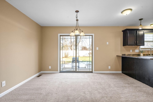 interior space featuring a notable chandelier, light carpet, visible vents, baseboards, and decorative light fixtures