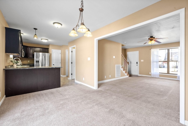 kitchen featuring light carpet, visible vents, baseboards, stainless steel refrigerator with ice dispenser, and pendant lighting