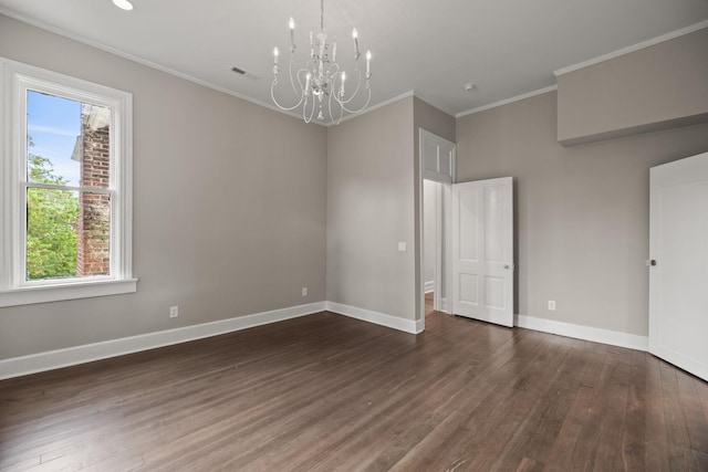 unfurnished room with an inviting chandelier, baseboards, dark wood-style flooring, and ornamental molding