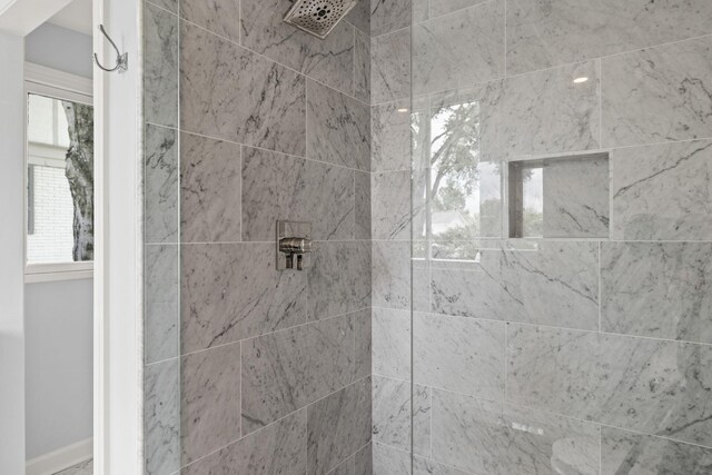 bathroom with a tile shower