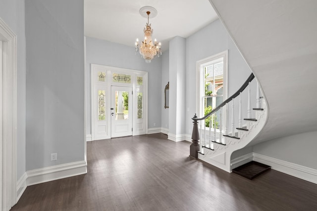 entrance foyer with a wealth of natural light, dark wood-style flooring, stairway, and baseboards