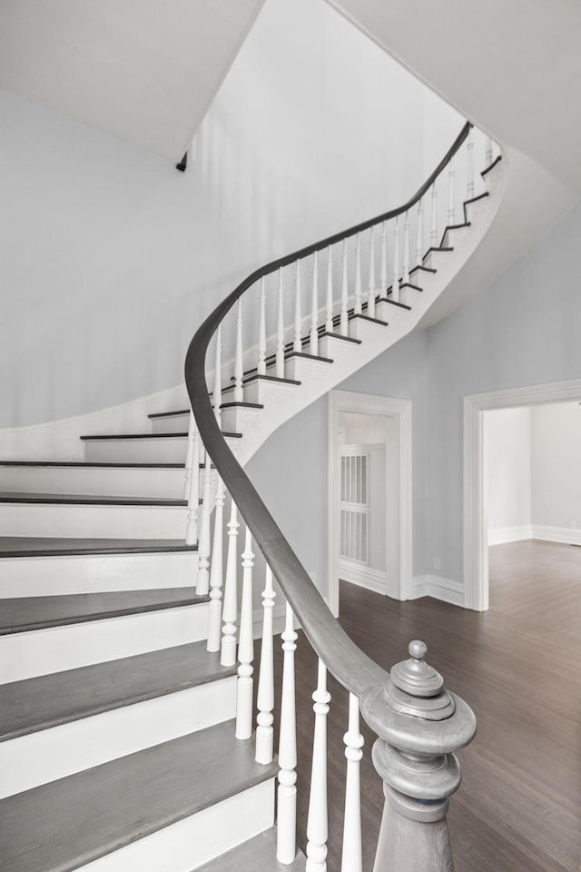 stairs featuring baseboards and wood finished floors