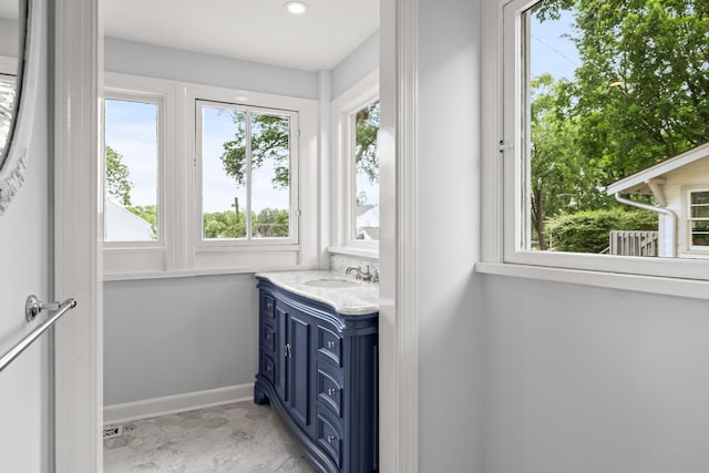 bathroom with recessed lighting, marble finish floor, vanity, and baseboards