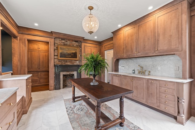 interior space featuring light countertops, a fireplace, a sink, and backsplash