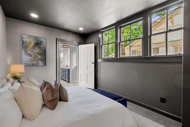 carpeted bedroom featuring baseboards and recessed lighting