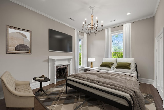 bedroom featuring dark wood-style flooring, visible vents, crown molding, and baseboards
