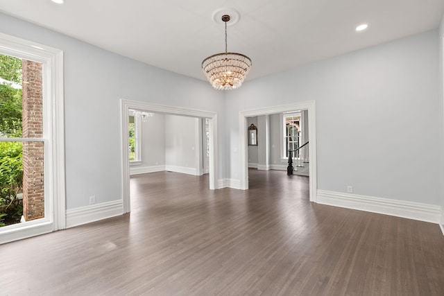 interior space featuring a chandelier, recessed lighting, dark wood finished floors, and baseboards