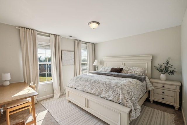 bedroom with carpet flooring, visible vents, and baseboards