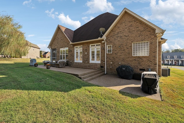 back of house featuring a lawn, crawl space, french doors, a patio area, and brick siding