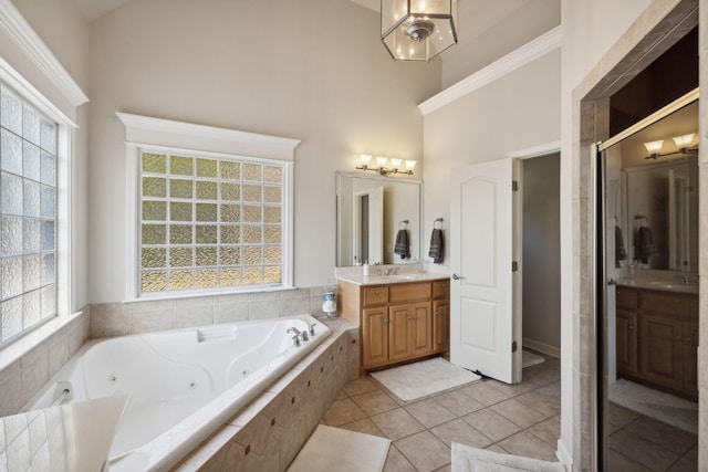 full bath featuring tile patterned flooring, a high ceiling, vanity, a shower stall, and a whirlpool tub