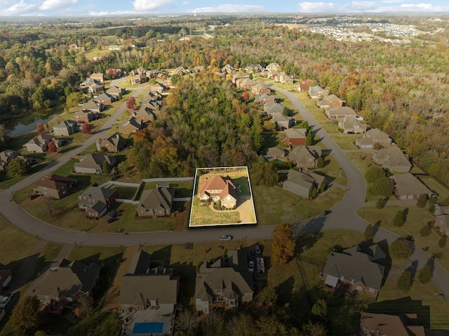 birds eye view of property featuring a residential view and a view of trees