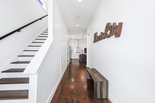 hallway featuring baseboards, stairway, dark wood-style flooring, and recessed lighting