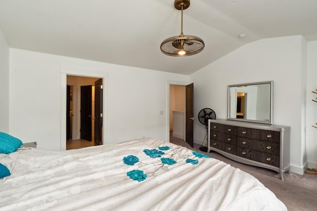 carpeted bedroom with vaulted ceiling and baseboards