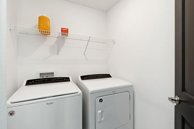 washroom with laundry area and independent washer and dryer