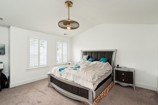 bedroom featuring lofted ceiling, baseboards, visible vents, and carpet flooring