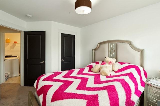 bedroom with carpet and washer / clothes dryer