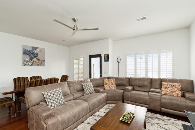 living room with a ceiling fan, dark wood-style flooring, and visible vents