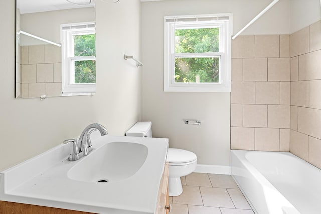 full bathroom with shower / tub combination, toilet, vanity, baseboards, and tile patterned floors