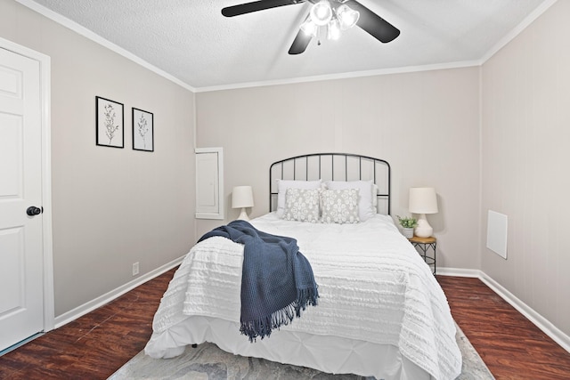 bedroom featuring ornamental molding, a ceiling fan, a textured ceiling, wood finished floors, and baseboards