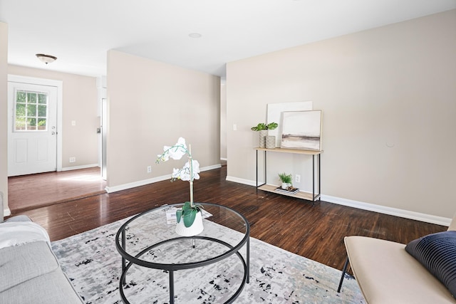 living room featuring baseboards and wood finished floors