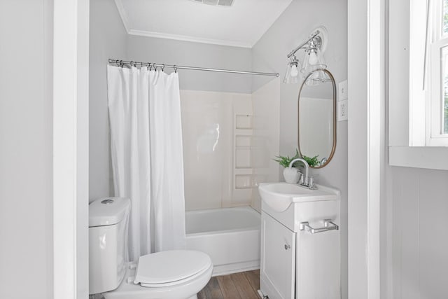 bathroom featuring toilet, wood finished floors, vanity, a healthy amount of sunlight, and shower / bath combination with curtain