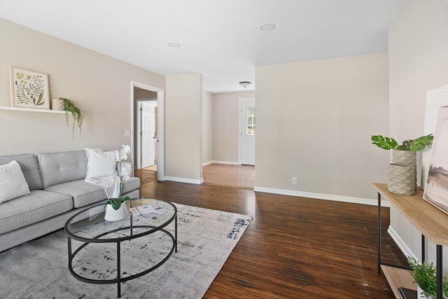 living room featuring wood-type flooring and baseboards