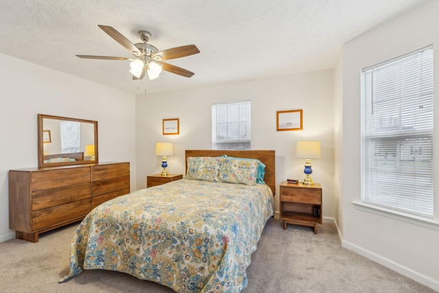 bedroom featuring a ceiling fan, a textured ceiling, baseboards, and carpet flooring