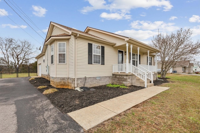 view of front of home featuring crawl space, covered porch, and a front lawn