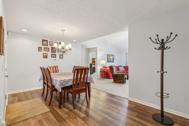 dining space with a textured ceiling, a chandelier, recessed lighting, baseboards, and hardwood / wood-style floors