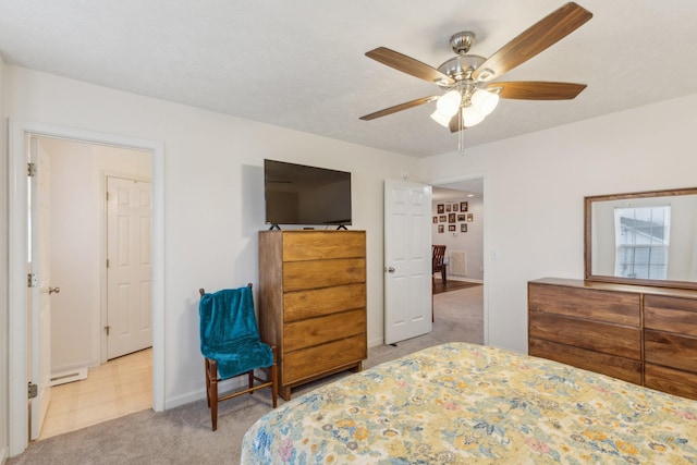 carpeted bedroom with a ceiling fan and baseboards