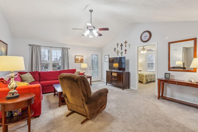 living area with a ceiling fan, light carpet, vaulted ceiling, and baseboards