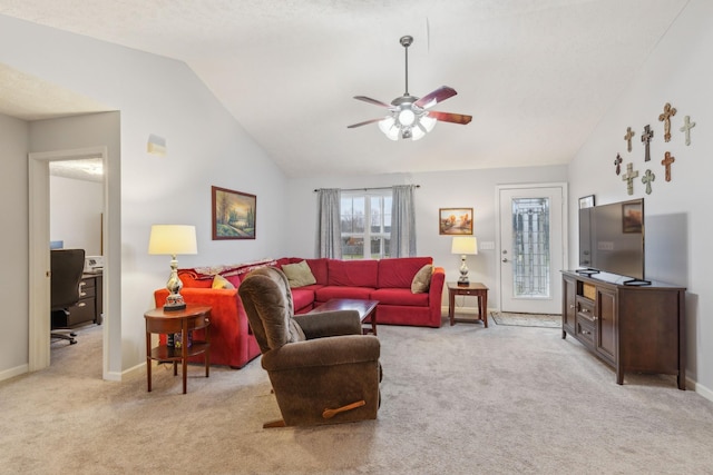 living area featuring light carpet, ceiling fan, baseboards, and vaulted ceiling