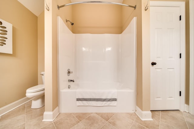 full bath featuring toilet, tile patterned flooring, baseboards, and tub / shower combination