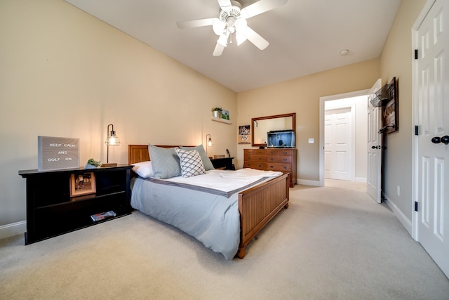 bedroom featuring light carpet, baseboards, a ceiling fan, and vaulted ceiling