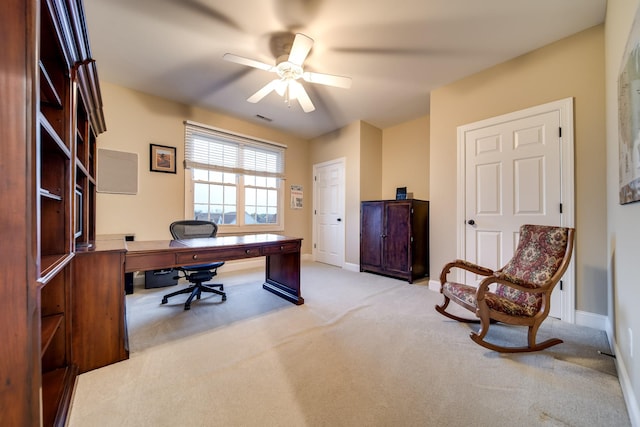office area with carpet flooring, visible vents, baseboards, and a ceiling fan