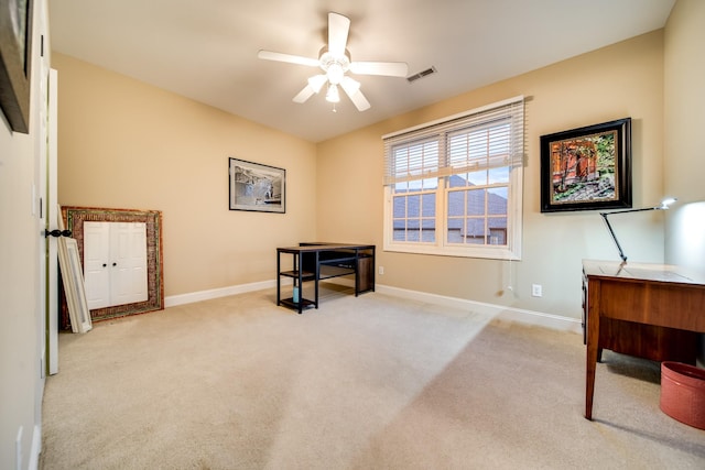 carpeted office space featuring visible vents, baseboards, and a ceiling fan