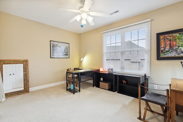 carpeted office with baseboards, a ceiling fan, and visible vents