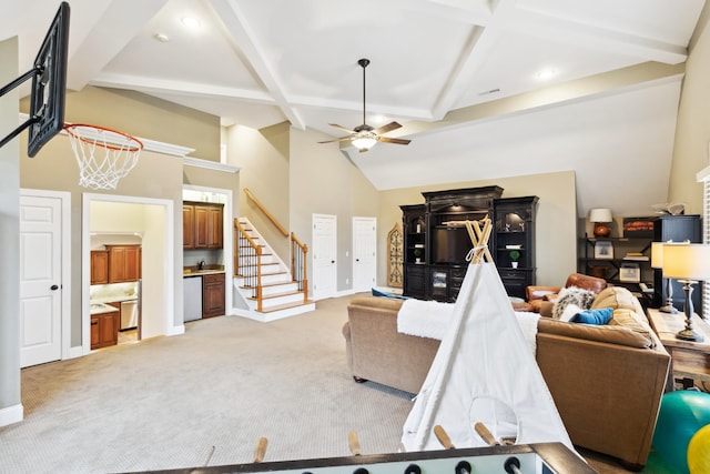living area with baseboards, a ceiling fan, stairway, high vaulted ceiling, and light colored carpet