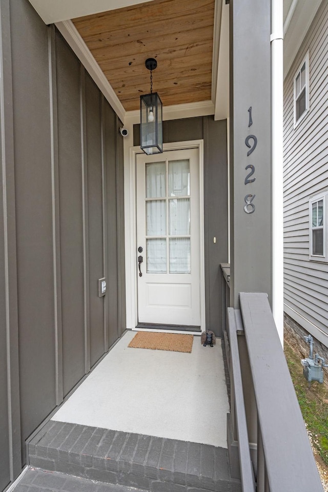 property entrance with a porch and board and batten siding