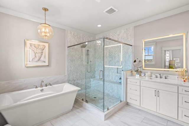 full bath with a freestanding bath, a stall shower, vanity, and visible vents