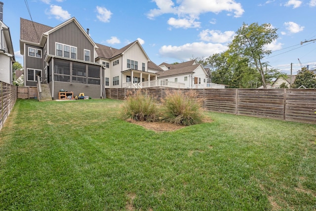 view of yard with a sunroom and a fenced backyard