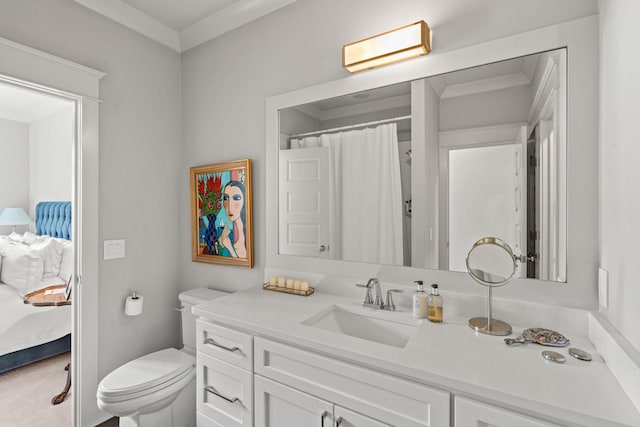 bathroom with ornamental molding, vanity, toilet, and ensuite bathroom